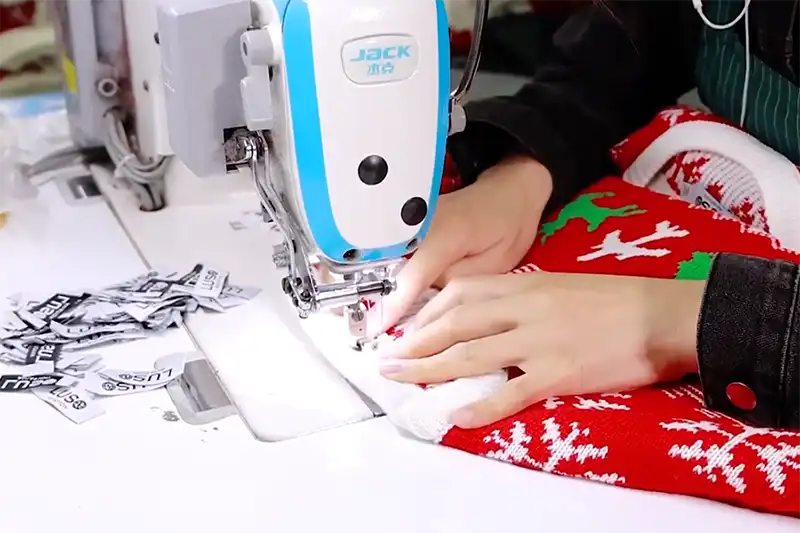 Workers carefully crafting knitted sweaters