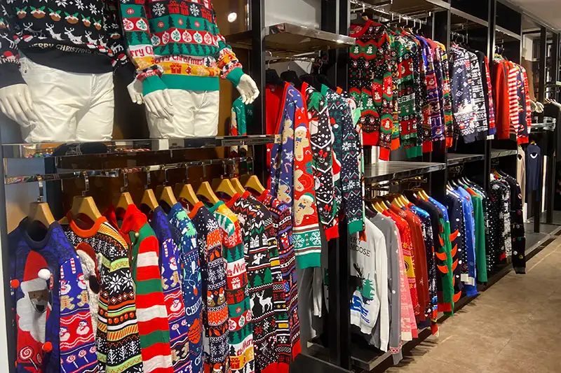 Garment sample room displaying Christmas jumpers samples