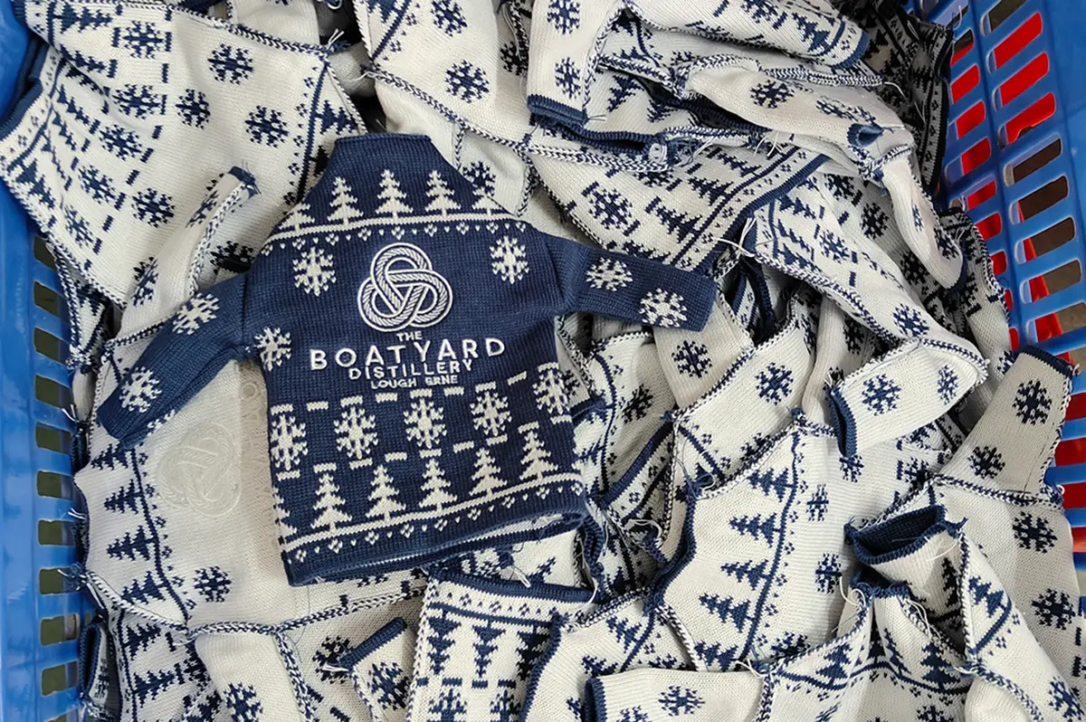 Checking a custom Christmas sweater sample before bulk production