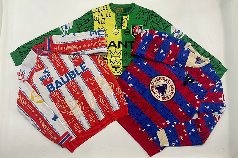 custom Christmas sweater samples displayed for client approval