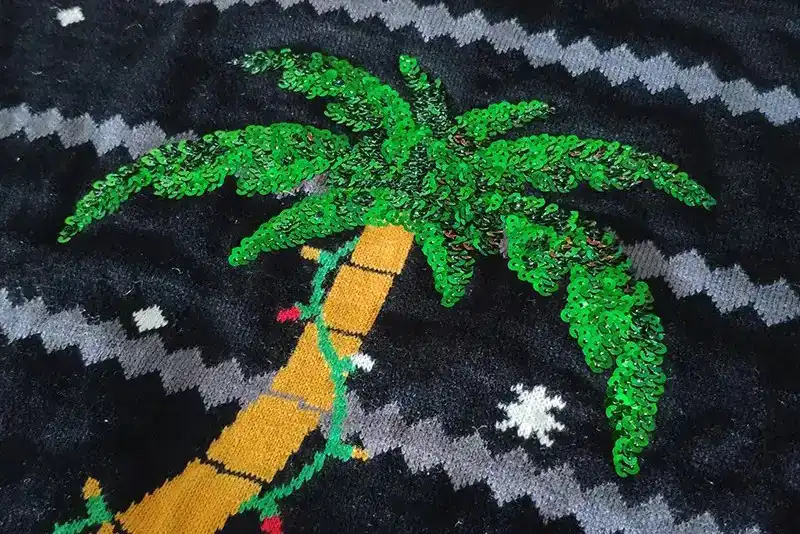 Sequin embroidery craftsmanship on custom Christmas sweater